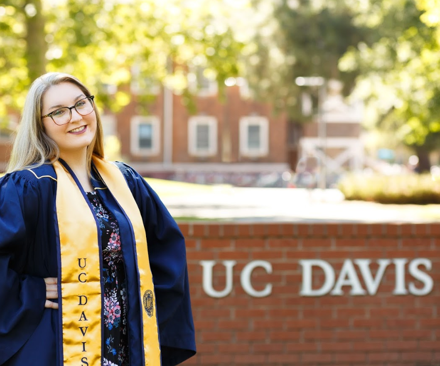 First-generation student, Chelsea Blankenship, smiling in a gold UC Davis stole.