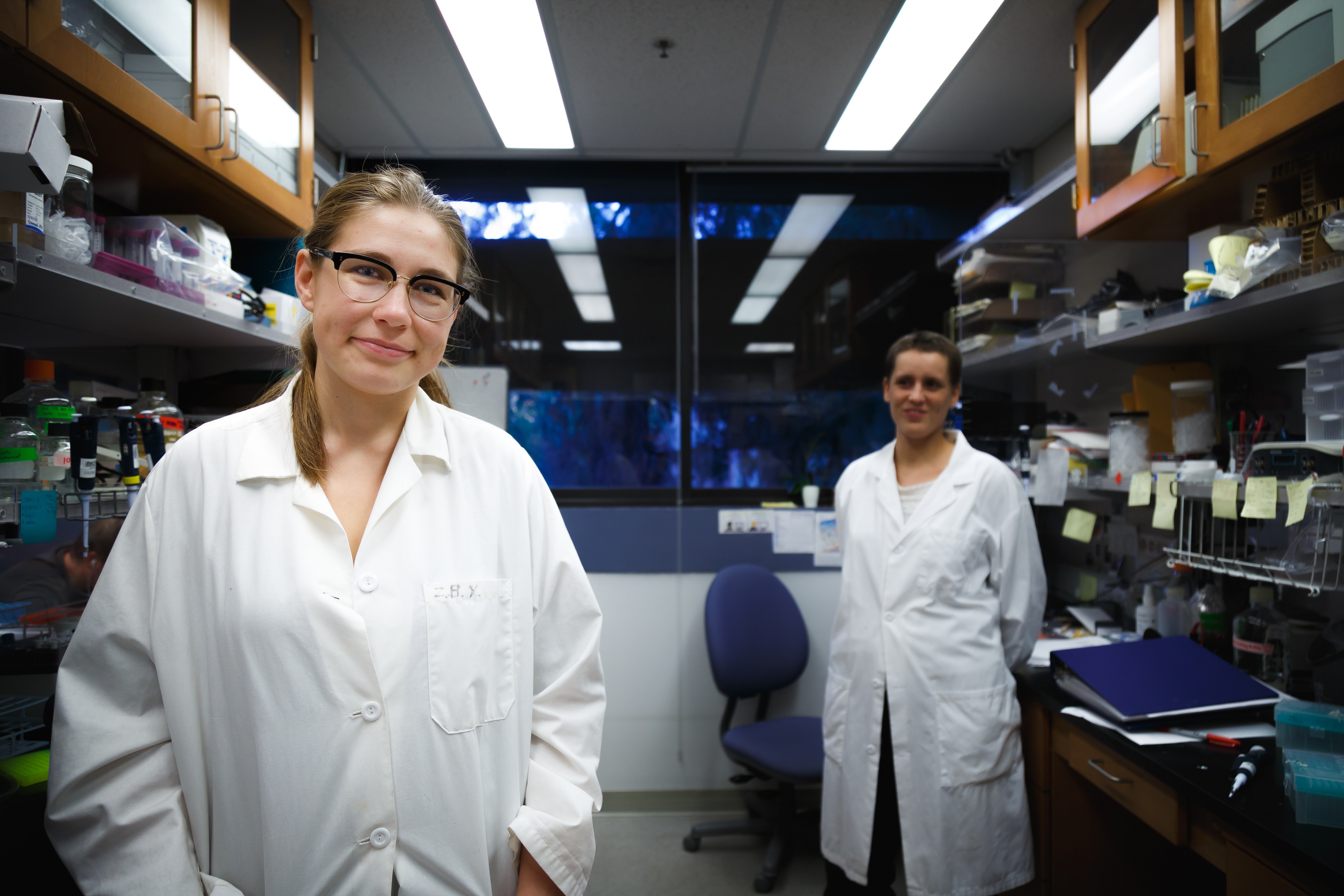Ariana Nagainis in a white coat in the research lab. 
