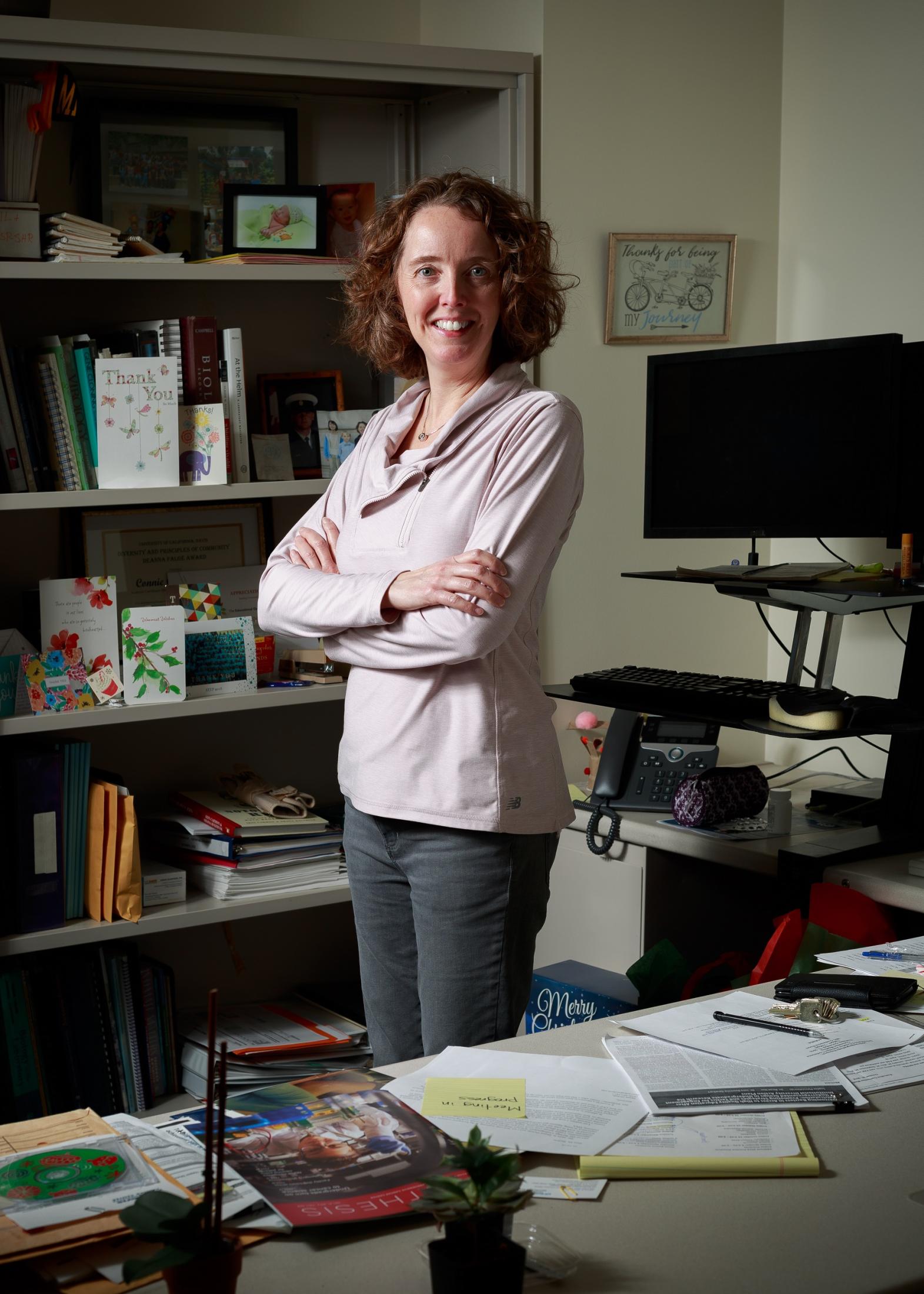 Connie Champagne standing in the office