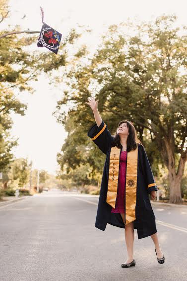first gen college student Gaby Gonzalez tosses her graduation cap