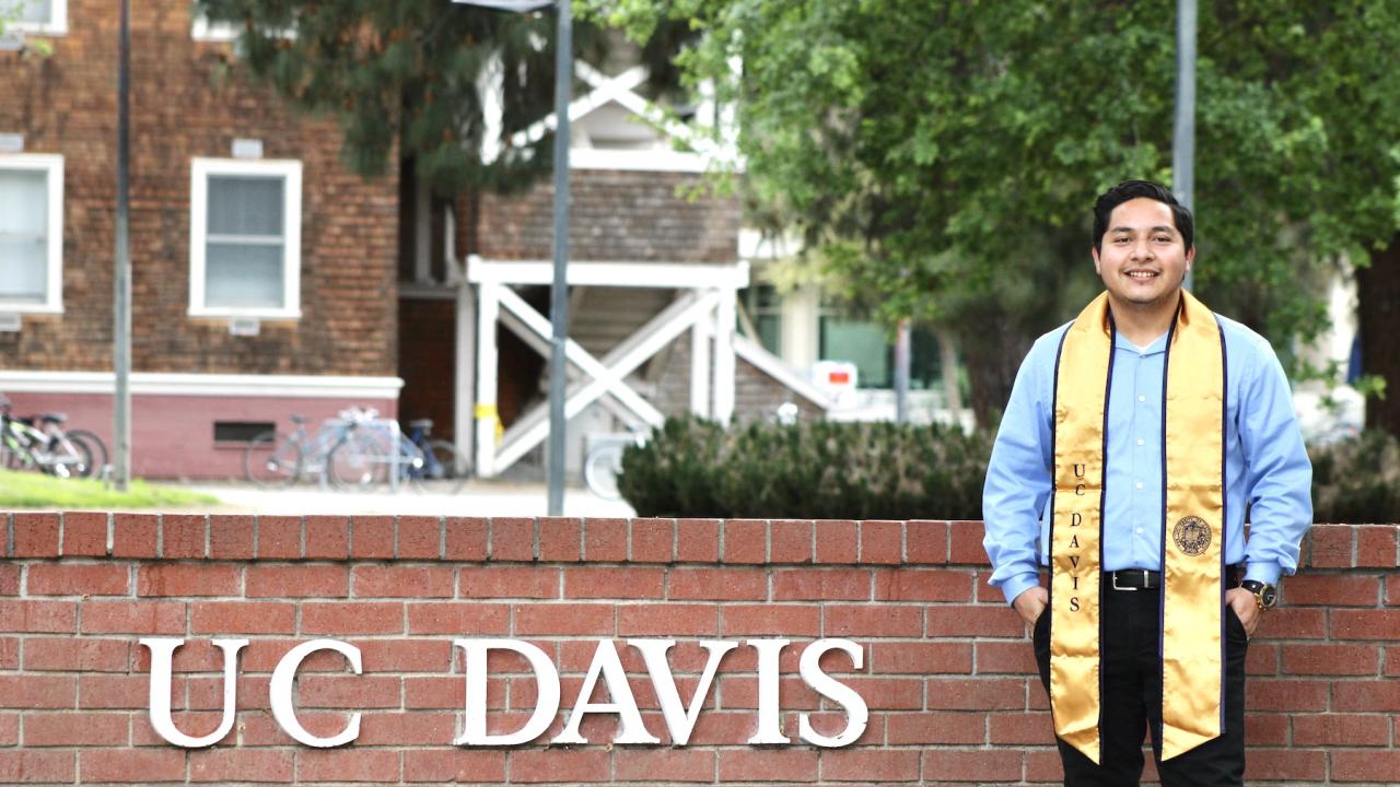 Irving Huerta '20 in front of the UC Davis sign