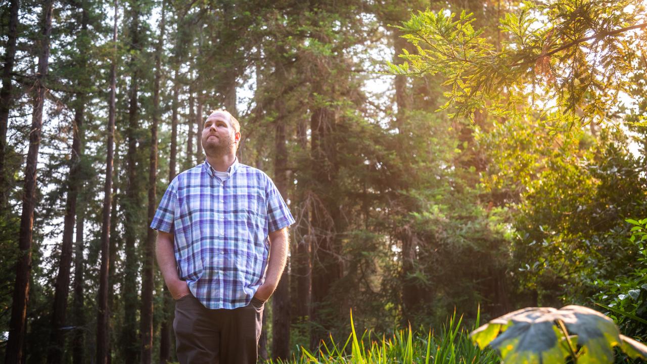 Photo: Daniel Oberbauer Joe Lee standing in the arboretum
