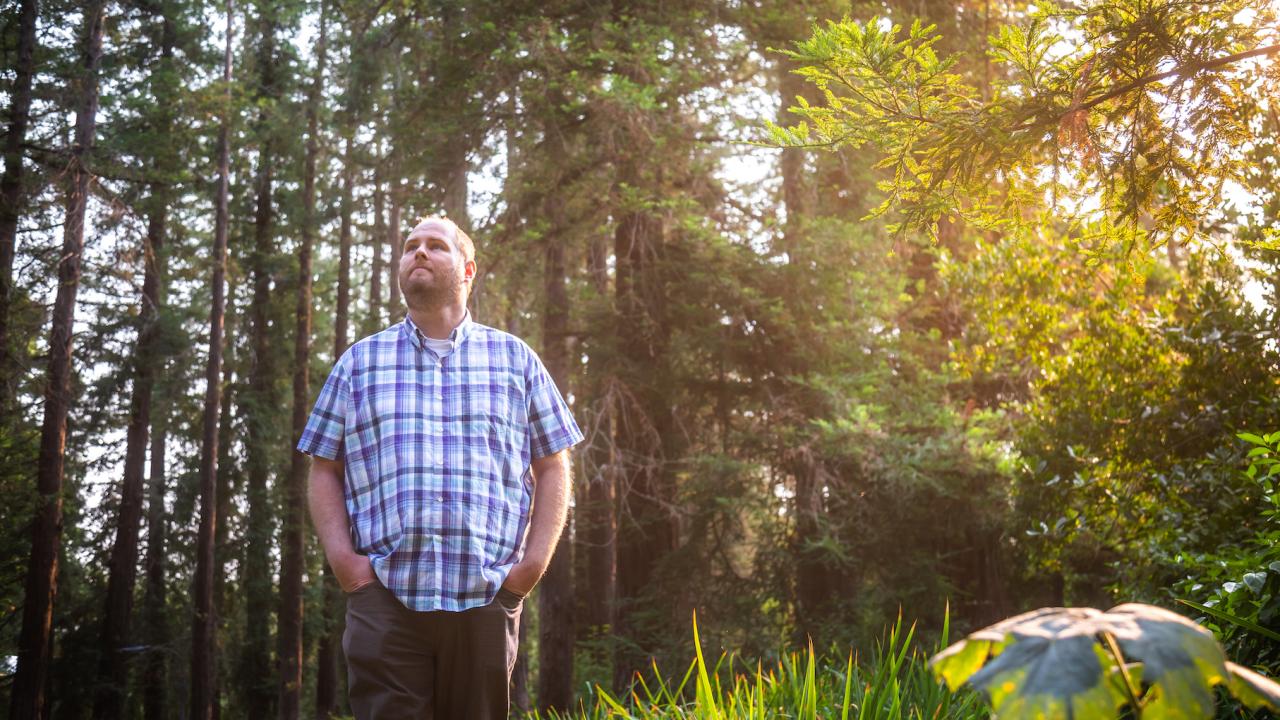 Joe Lee standing in the arboretum