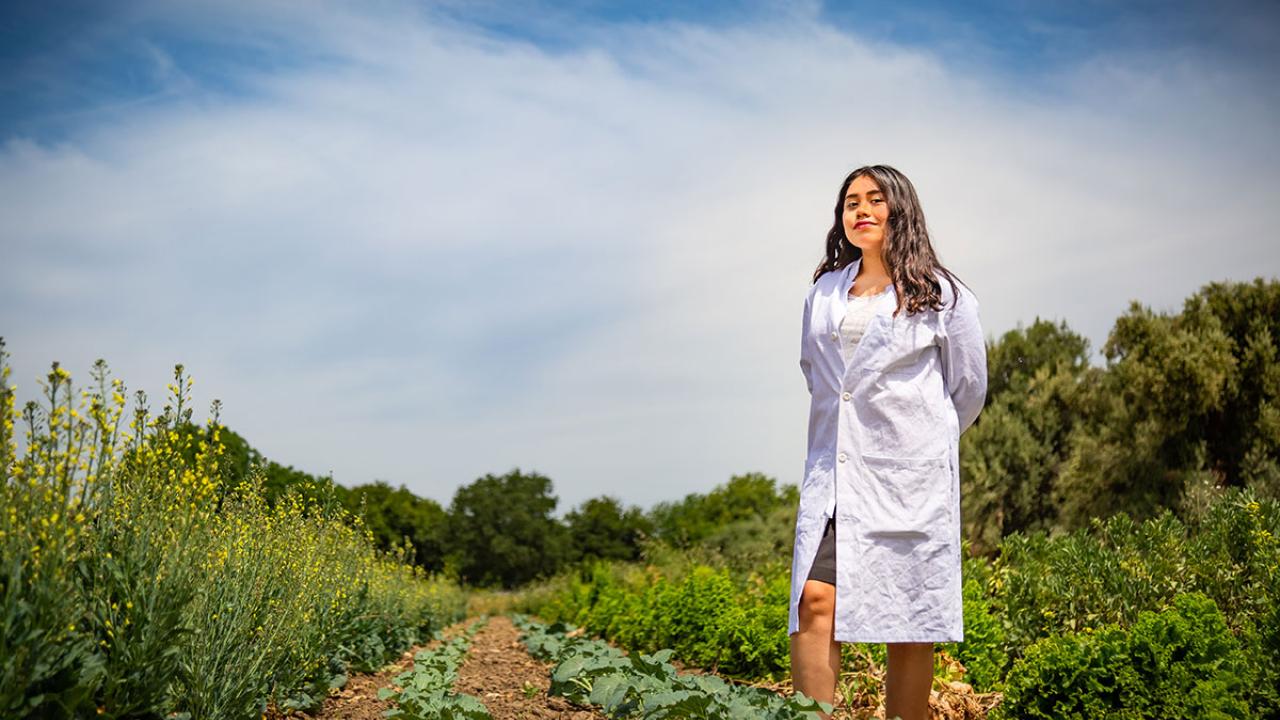 First Generation College Student Yilda Korpela wearing a labcoat