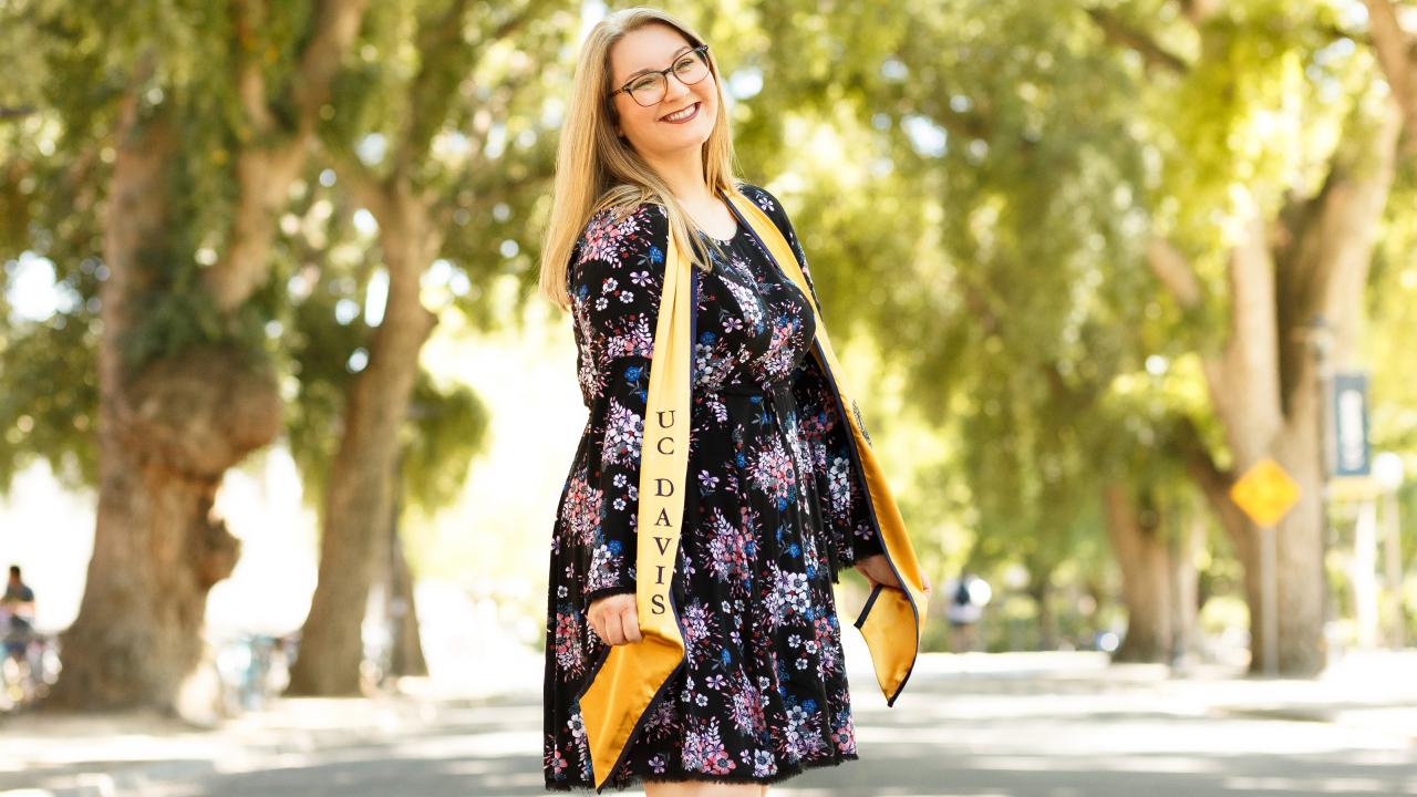 Photo: Daniel Oberbauer First-generation student, Chelsea Blankenship, smiling in a gold UC Davis stole.