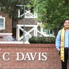 Irving Huerta '20 in front of the UC Davis sign
