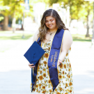 First-generation student, Roseanne Gorelik, standing proudly with her first-gen stole.