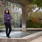 First-generation college student, Joyce Zamorano standing in front of the UC Davis Welcome Center fountain.