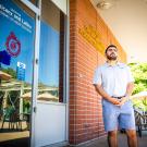 First Generation College Transfer Student, Jose Macias, stands in front of the Center for Chicanx and Latinx Academic Student Success. 