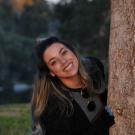Evelyn Alvarez behind a tree